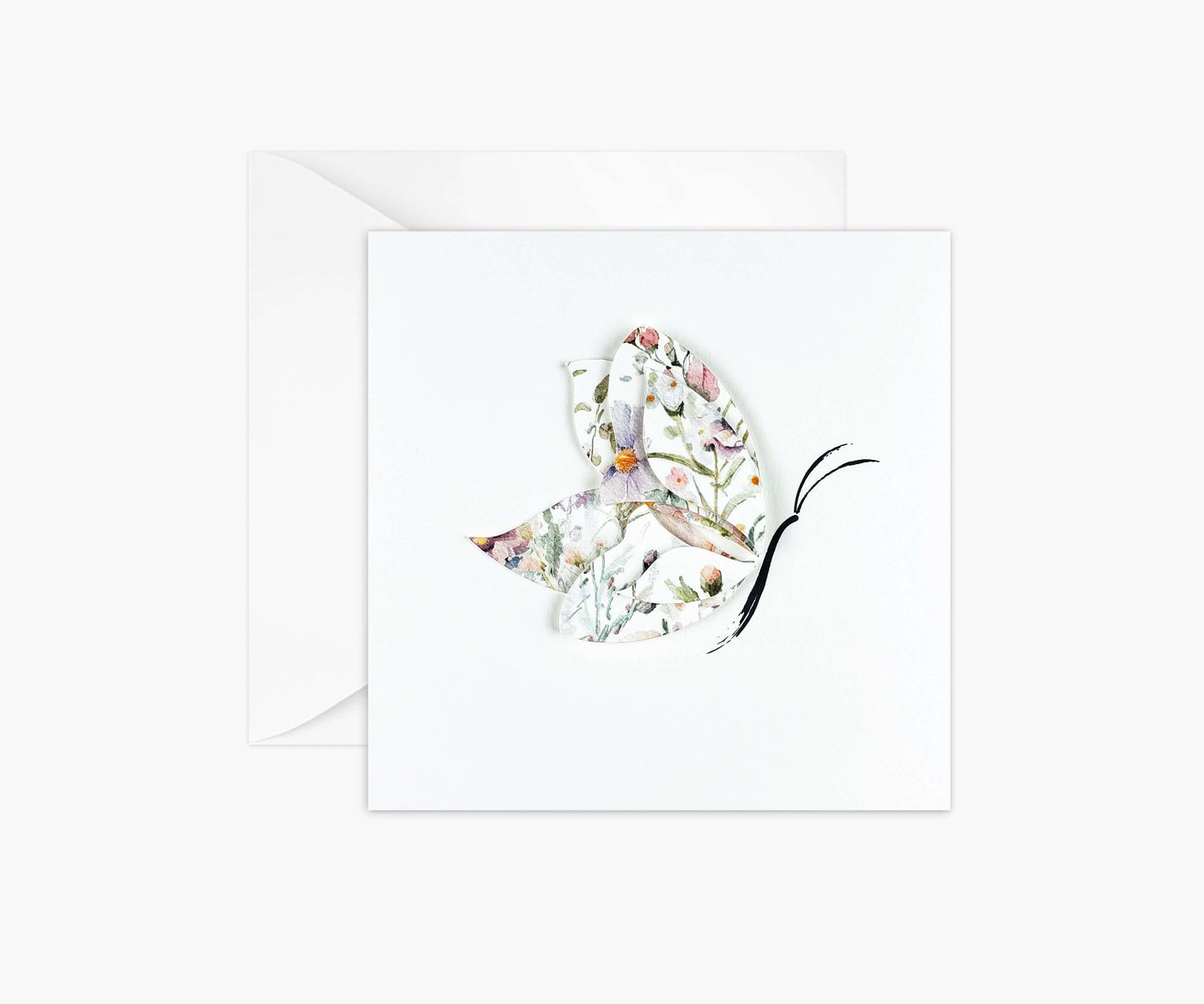 Butterfly die cut from floral patterned paper and layered