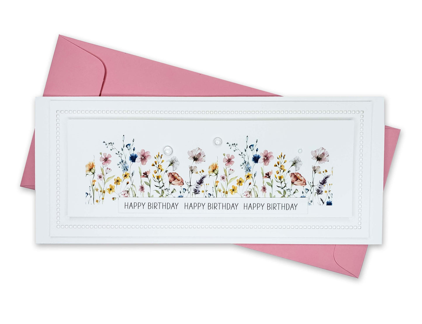 Birthday card with die cut edges and a beautiful row of colorful wildflowers and dew drops