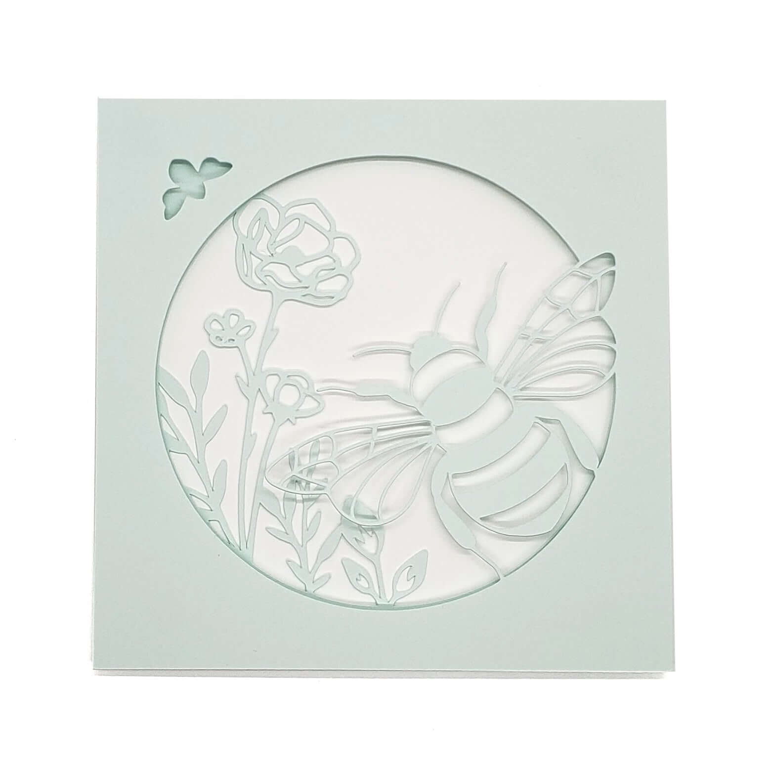 Die cut, layered card of  bee with flowers on light aqua card stock