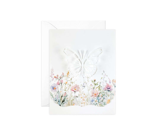 Die cut butterfly in a field of wildflowers with a decorative edge