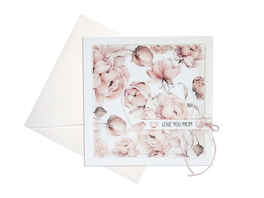 Die cut and embossed Mother's Day card with a pink floral pattern and a pink twine bow