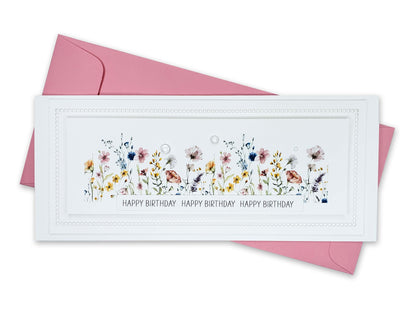 Birthday card with die cut edges and a beautiful row of colorful wildflowers and dew drops