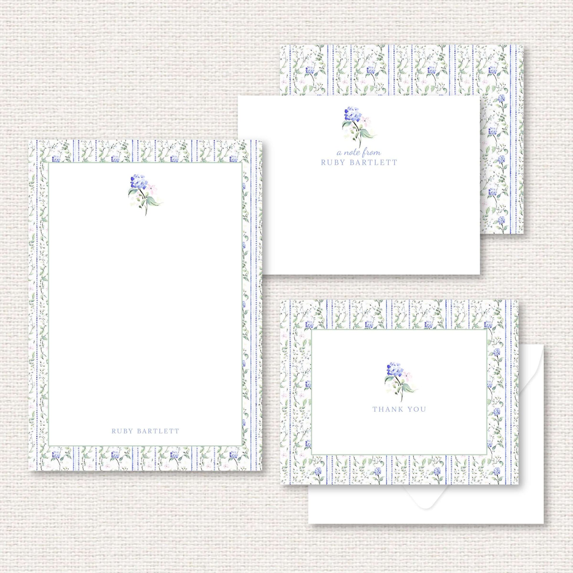 The Eloise Suite gift set includes a grand-millennial pattern applied to a personalized notepad, personalized flat not, and thank you cards