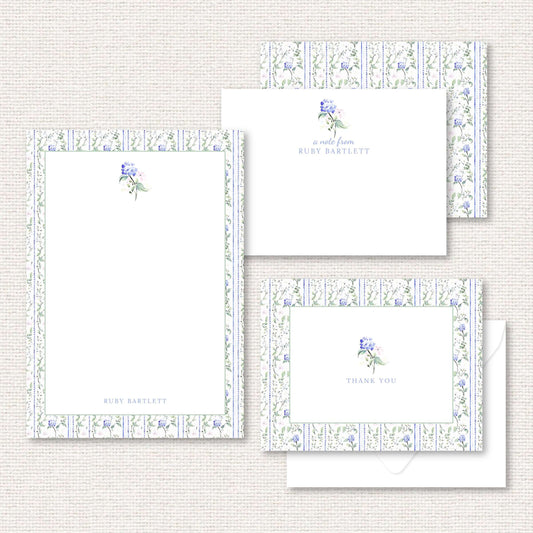 The Eloise Suite gift set includes a grand-millennial pattern applied to a personalized notepad, personalized flat not, and thank you cards