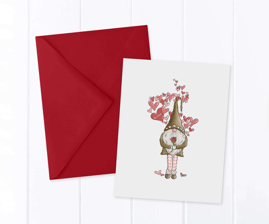 Valentine Gnome holding a red rose surrounded by pink and red hearts