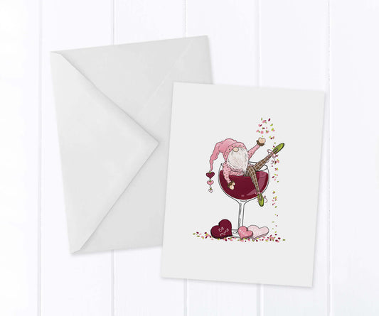 Valentine Gnome sitting in a glass of red wine throwing confetti